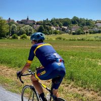 Le Loop kit, solo rider, green countryside and village backdrop
