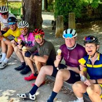 Line of cyclists sitting, ice creams