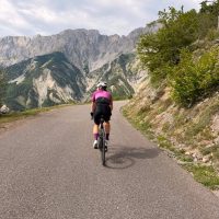 Mountain road, solo rider, pink jersey
