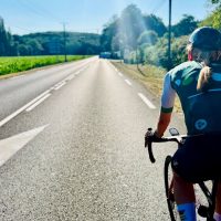 Sun, female cyclist, tour tarmac